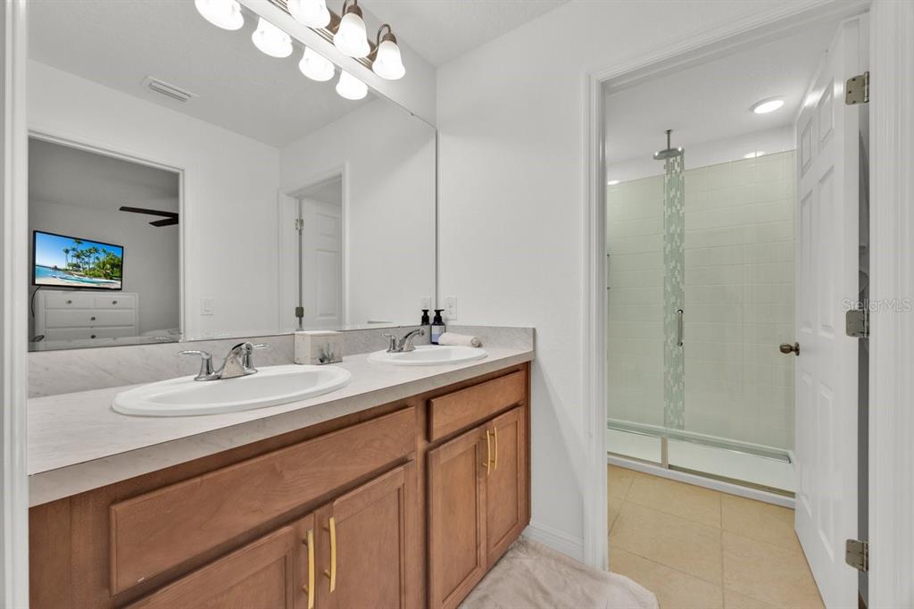 5237 Royal Point Avenue Kissimmee, FL 34746 - Photo 16 of 28 a bathroom with a double vanity sink and a mirror