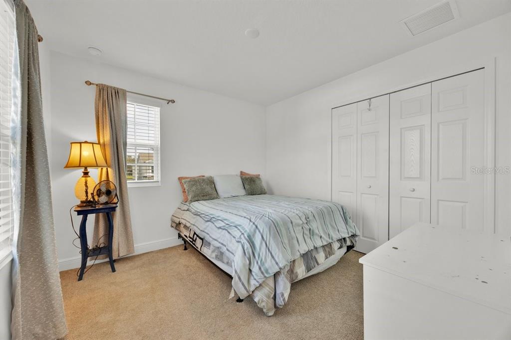 5237 Royal Point Avenue Kissimmee, FL 34746 - Photo 21 of 28 a spacious bedroom with a bed and a closet