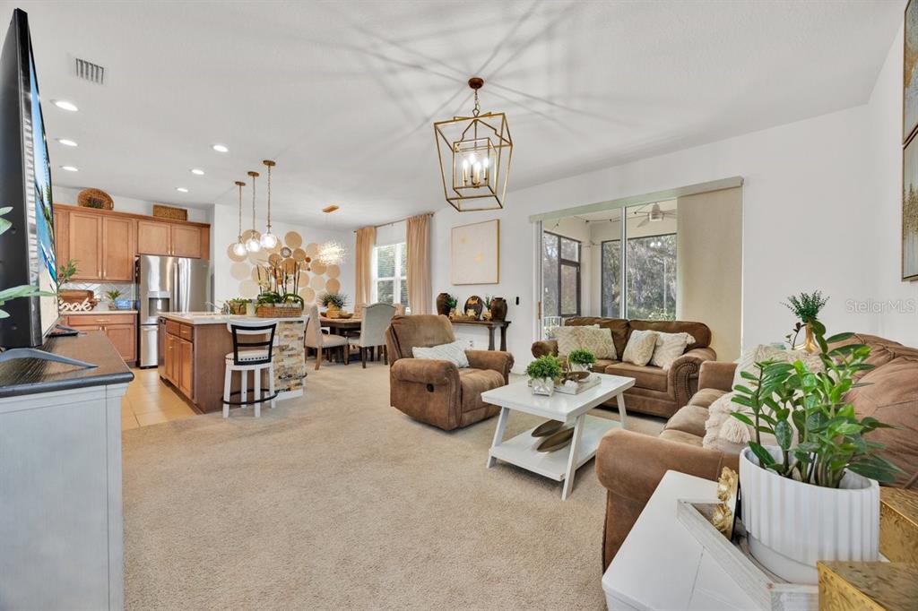 5237 Royal Point Avenue Kissimmee, FL 34746 - Photo 5 of 28 a living room with furniture and a chandelier