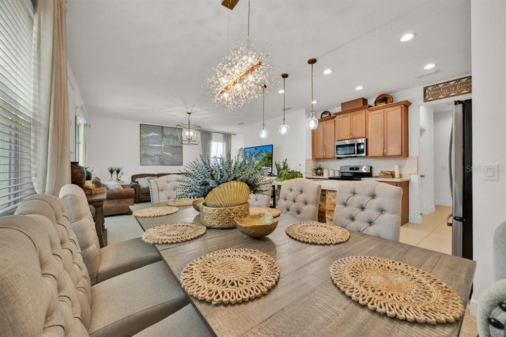 5237 Royal Point Avenue Kissimmee, FL 34746 - Photo 10 of 28 a living room with furniture kitchen view and a chandelier