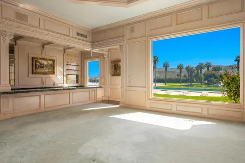 a kitchen with granite countertop a sink and cabinets