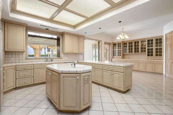 a bathroom with a granite countertop sink toilet and mirror