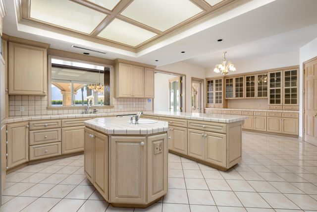 a bathroom with a granite countertop sink toilet and mirror