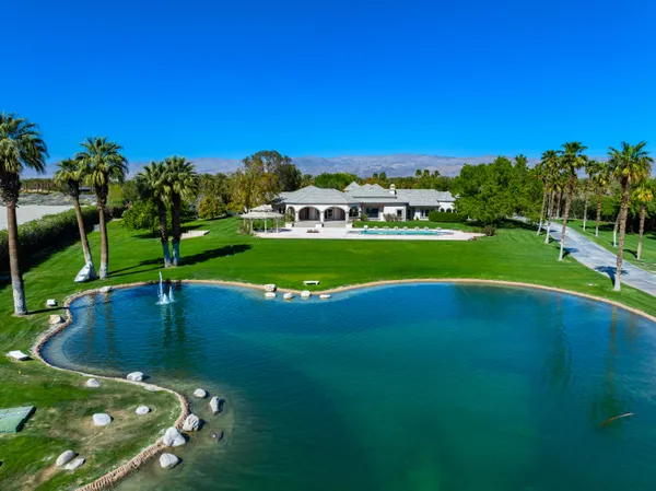 a view of a swimming pool and a yard