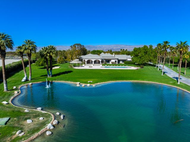 a view of a swimming pool and a yard