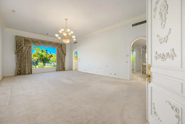 a view of a kitchen with white cabinets