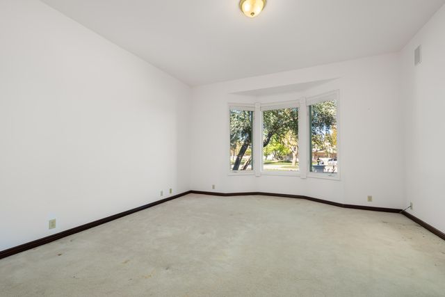 a kitchen with stainless steel appliances granite countertop a refrigerator a stove a sink and a microwave