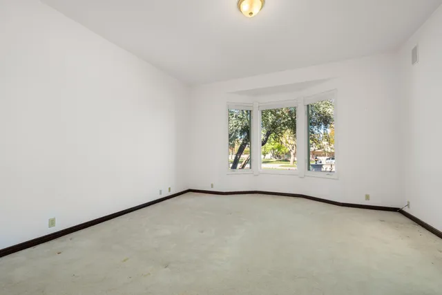 a kitchen with stainless steel appliances granite countertop a refrigerator a stove a sink and a microwave