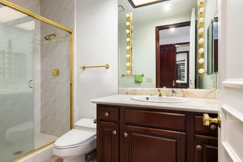 a kitchen with stainless steel appliances granite countertop a refrigerator a stove a sink and a refrigerator with wooden floor