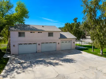 a bathroom with a granite countertop sink a toilet a mirror and bathtub