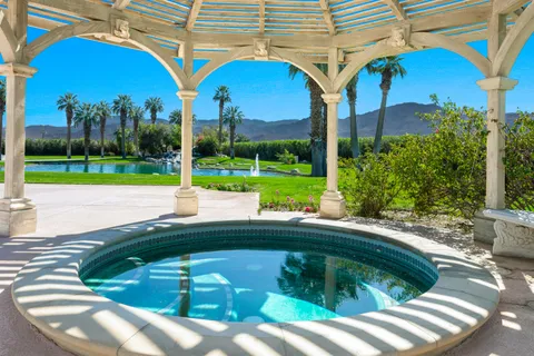 a view of a backyard with swimming pool
