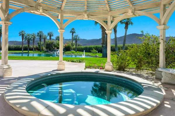 a view of a backyard with swimming pool