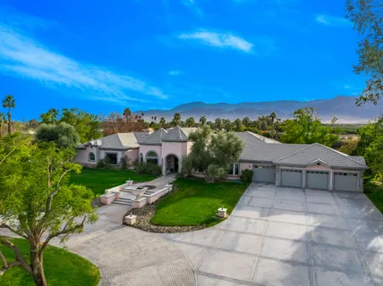 a front view of a house with a garden and pathway
