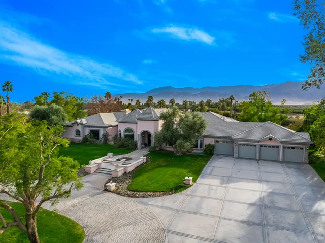 a front view of a house with a garden and pathway