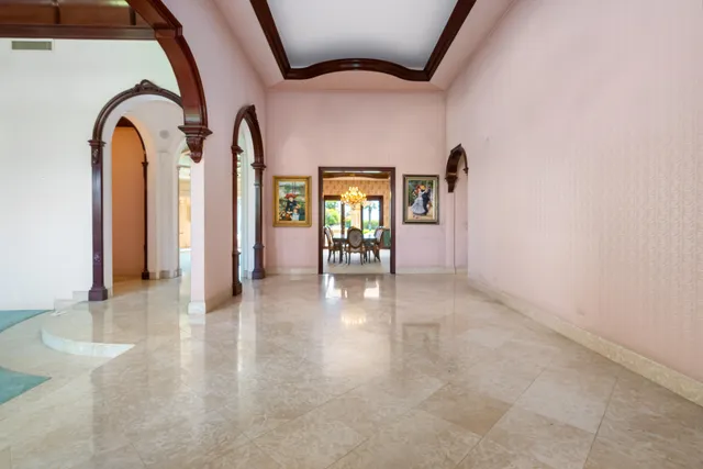 a view of a dining room with furniture and a chandelier