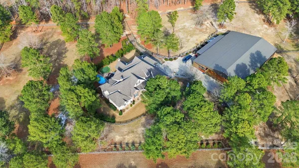an aerial view of a house with garden space and street view