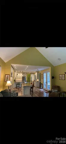 a view of a livingroom with workspace and a window