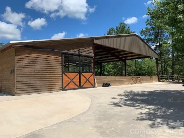 a view of a big house with a big yard and a large tree