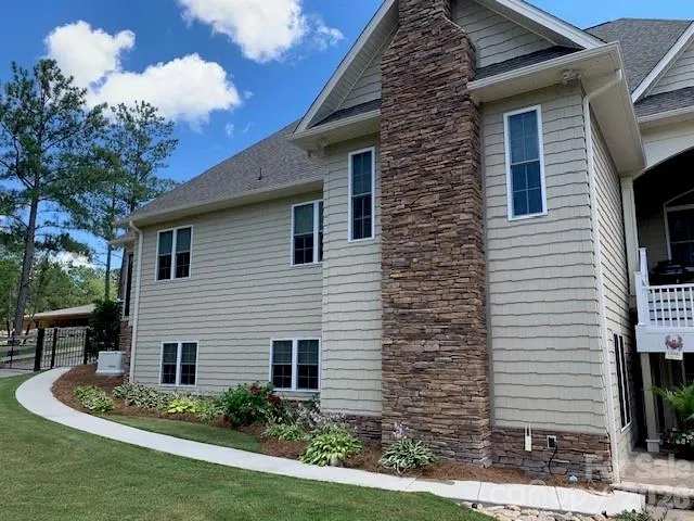 a living room with furniture a fireplace and a large window