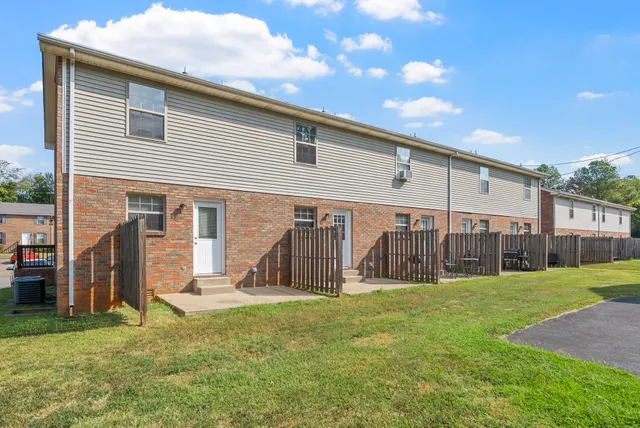 a view of a house with backyard and porch
