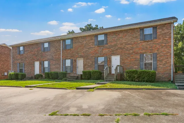 a view of a brick building next to a yard