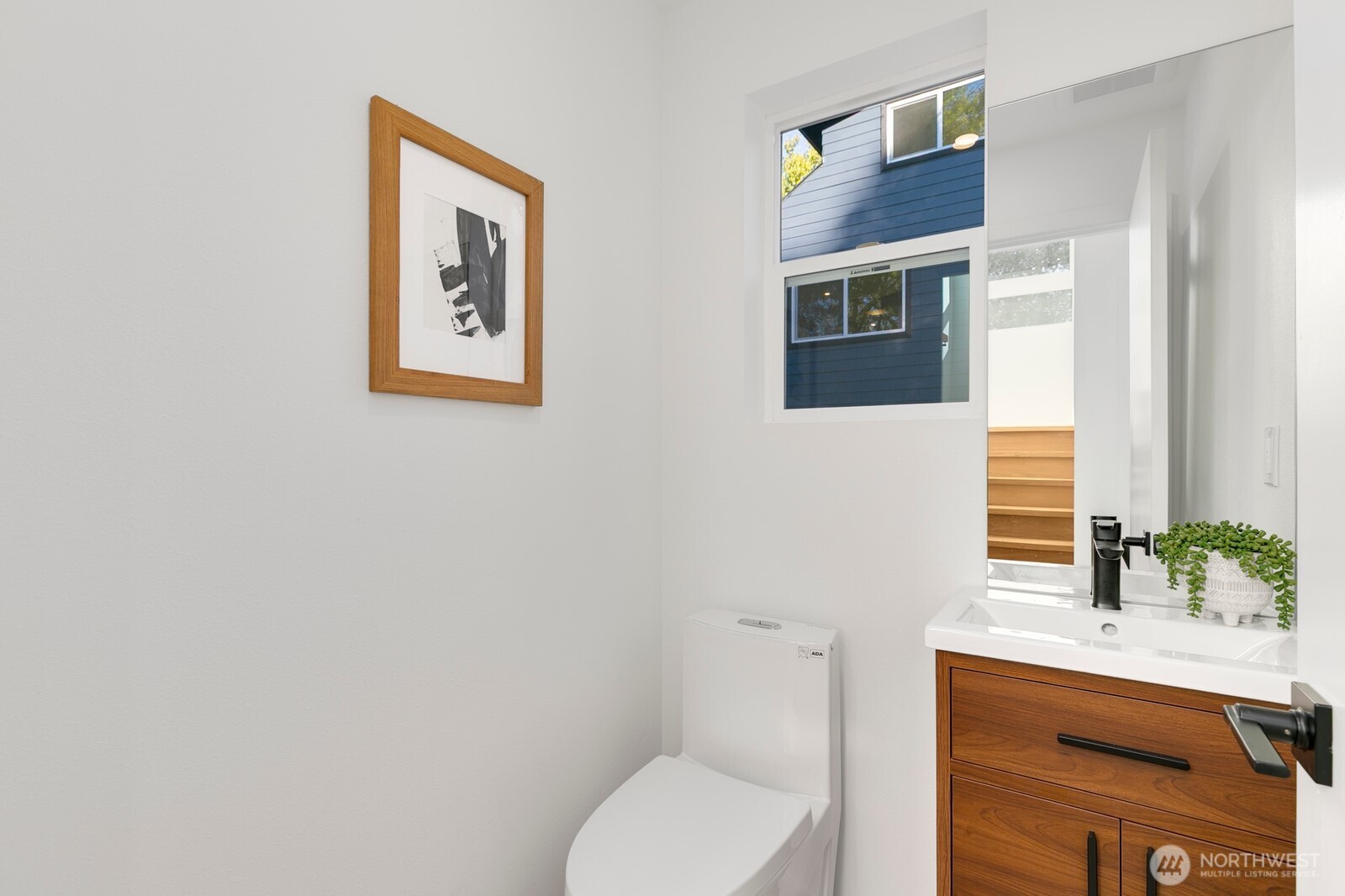 4531 26th Avenue Southwest Seattle, WA 98106 - Photo 7 of 22 a bathroom with a toilet a sink and mirror