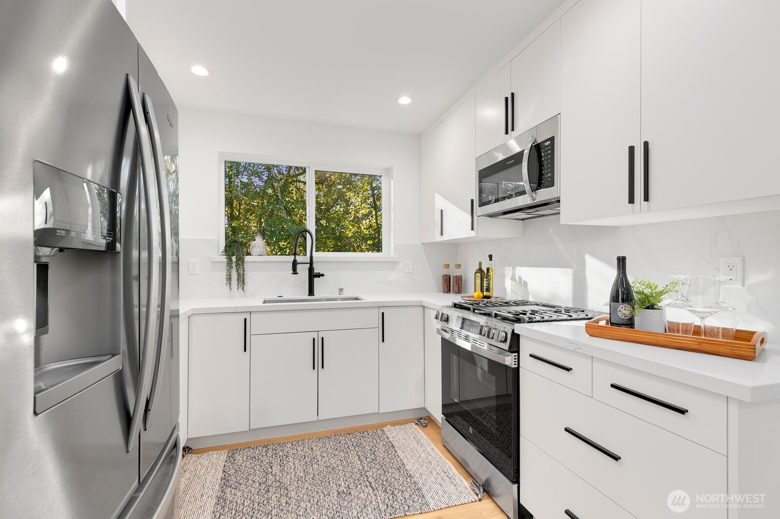 4531 26th Avenue Southwest Seattle, WA 98106 - Photo 9 of 22 a kitchen with stainless steel appliances granite countertop a refrigerator sink and stove