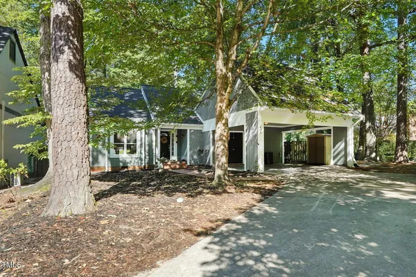 a view of a house with a tree in front