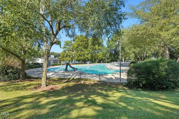a view of a swimming pool with a table and chairs