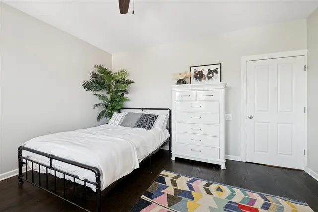 a bedroom with a bed and a potted plant