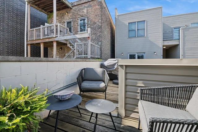 a balcony with table and chairs
