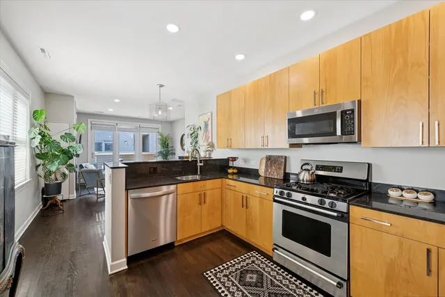 a kitchen with a sink appliances and cabinets