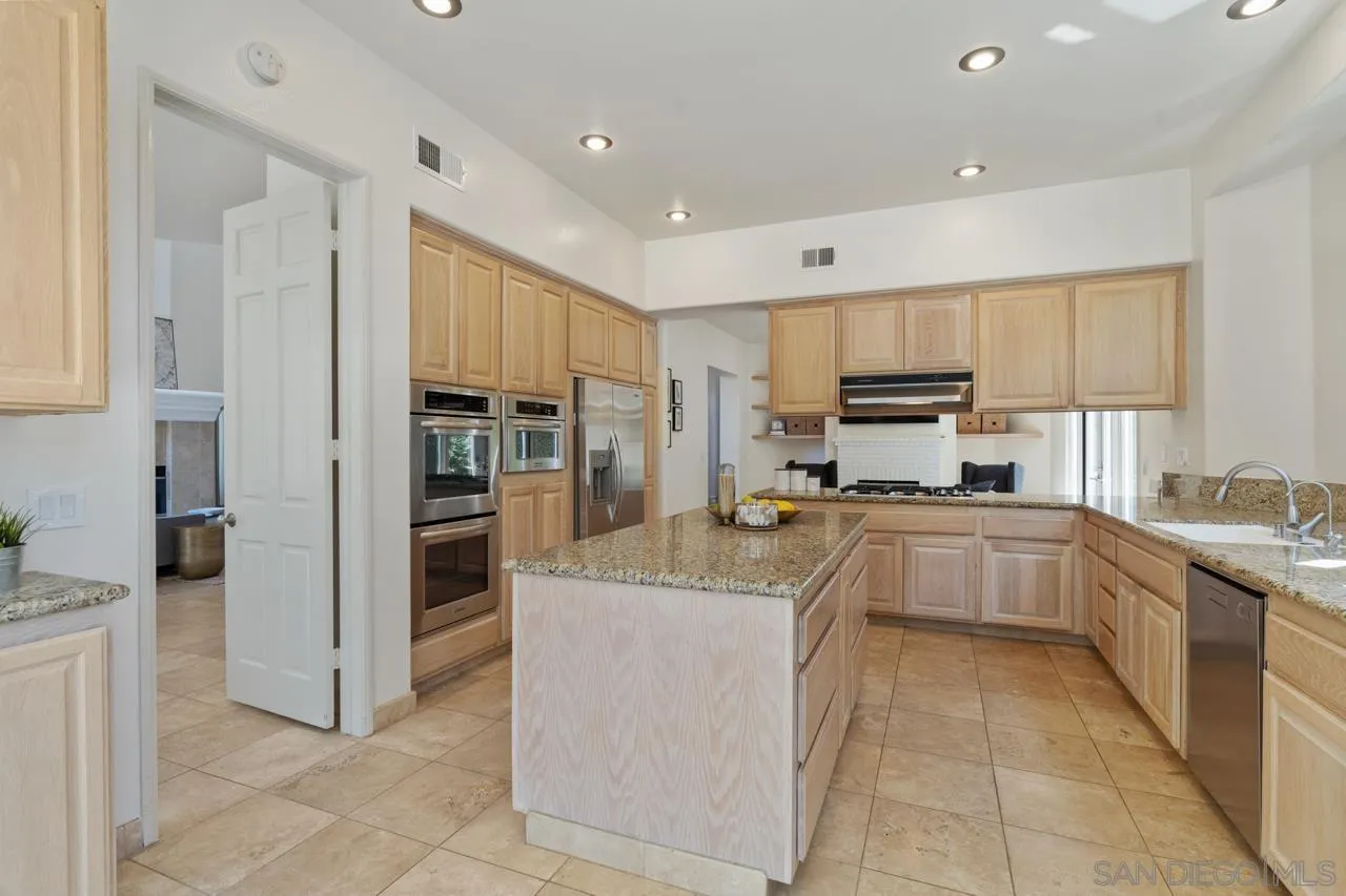 9678 Claiborne Square La Jolla, CA 92037 - Photo 14 of 38 a large kitchen with stainless steel appliances lots of counter top space