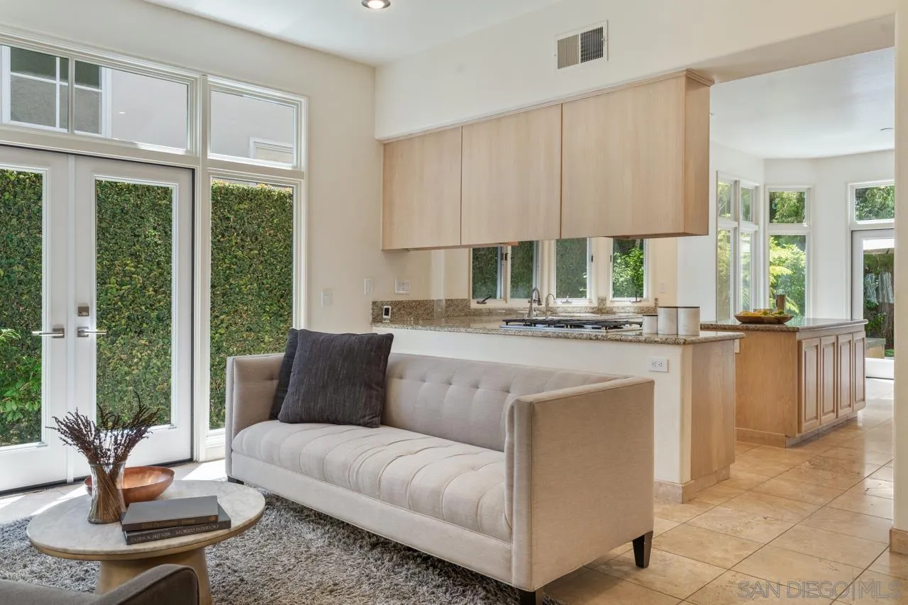 9678 Claiborne Square La Jolla, CA 92037 - Photo 18 of 38 a living room with kitchen island furniture and a potted plant