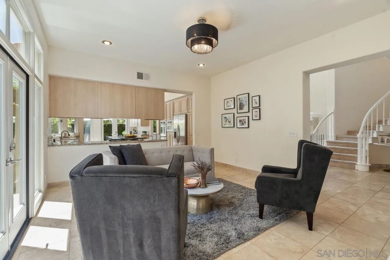 9678 Claiborne Square La Jolla, CA 92037 - Photo 19 of 38 a living room with furniture and a large window