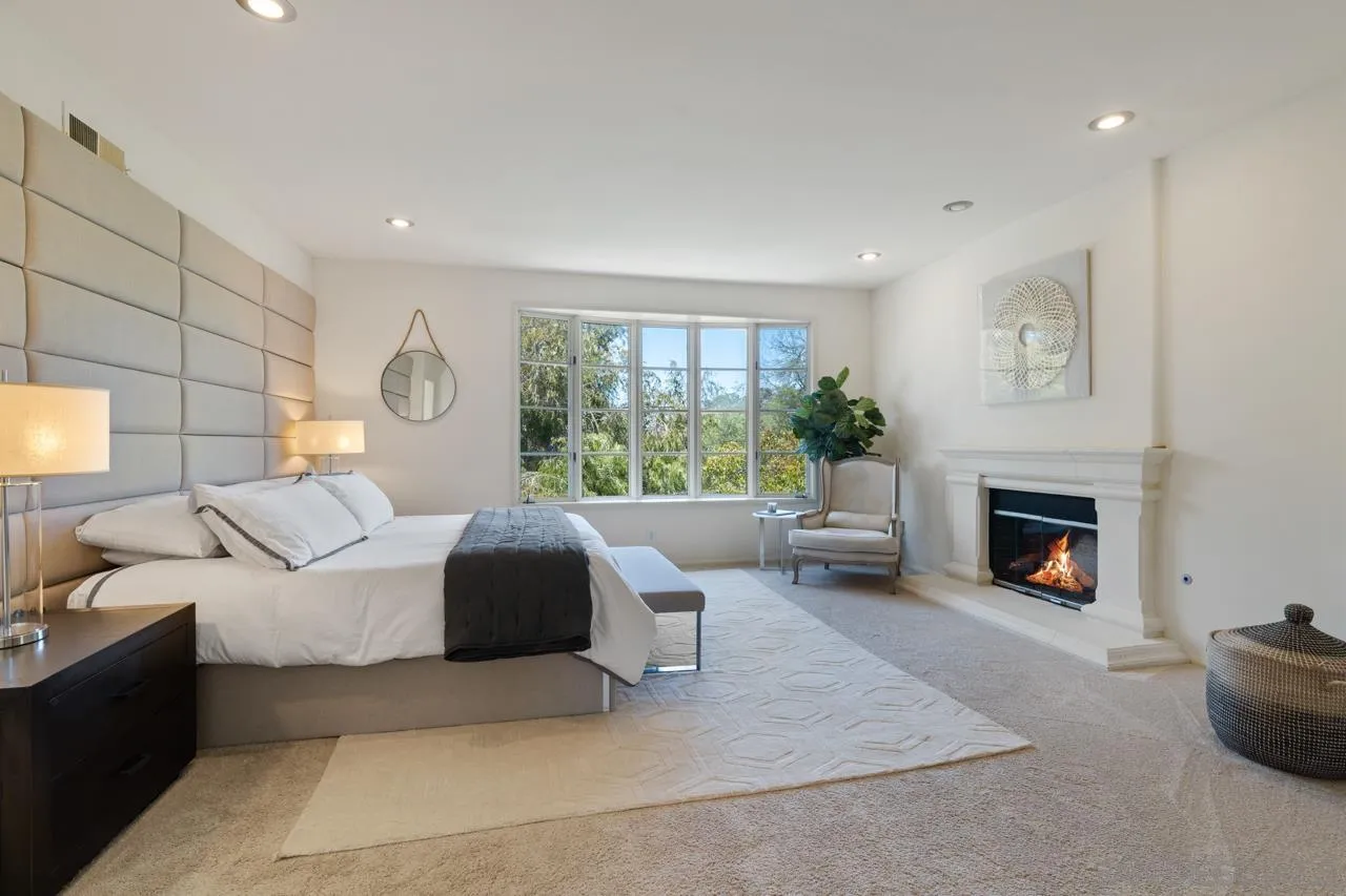 9678 Claiborne Square La Jolla, CA 92037 - Photo 21 of 38 a living room with furniture a fireplace and a large window