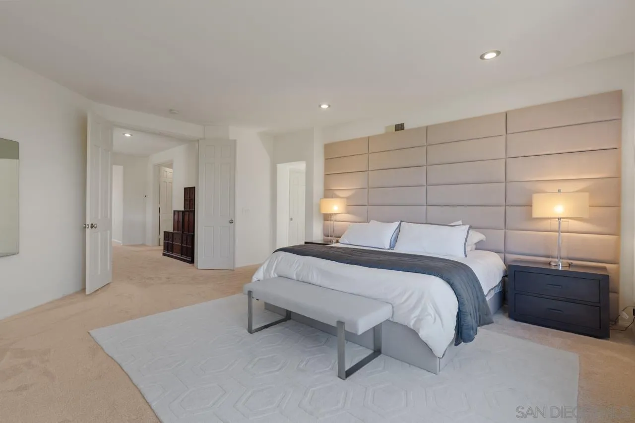 9678 Claiborne Square La Jolla, CA 92037 - Photo 22 of 38 a spacious bedroom with a bed and a walk in closet