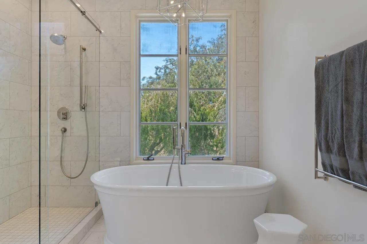 9678 Claiborne Square La Jolla, CA 92037 - Photo 25 of 38 a white bath tub sitting next to a shower