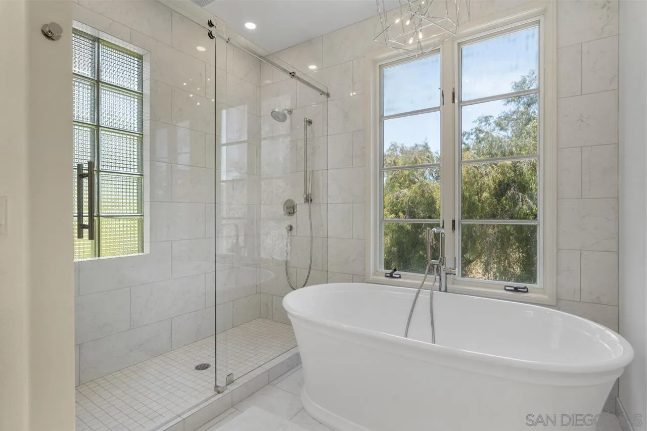 9678 Claiborne Square La Jolla, CA 92037 - Photo 26 of 38 a bathroom with a bathtub and shower