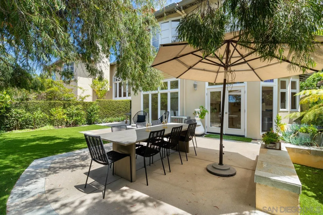 9678 Claiborne Square La Jolla, CA 92037 - Photo 3 of 38 a view of a patio with table and chairs and potted plants