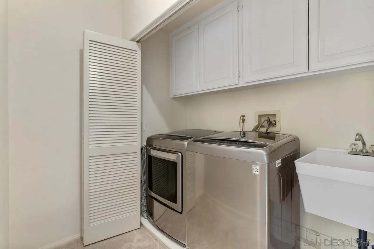 9678 Claiborne Square La Jolla, CA 92037 - Photo 34 of 38 a view of storage and utility room with washer and dryer