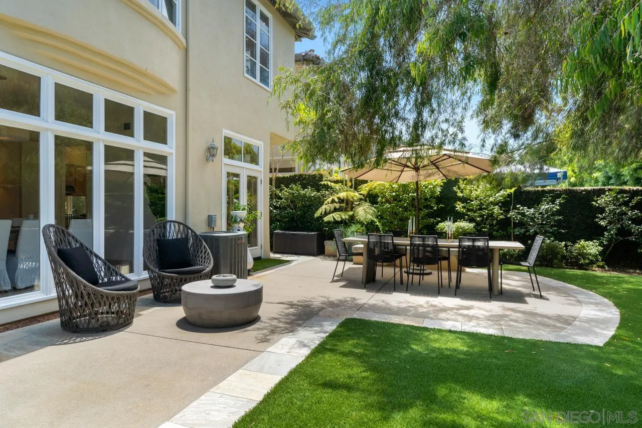 9678 Claiborne Square La Jolla, CA 92037 - Photo 36 of 38 a view of a patio with table and chairs potted plants with large tree