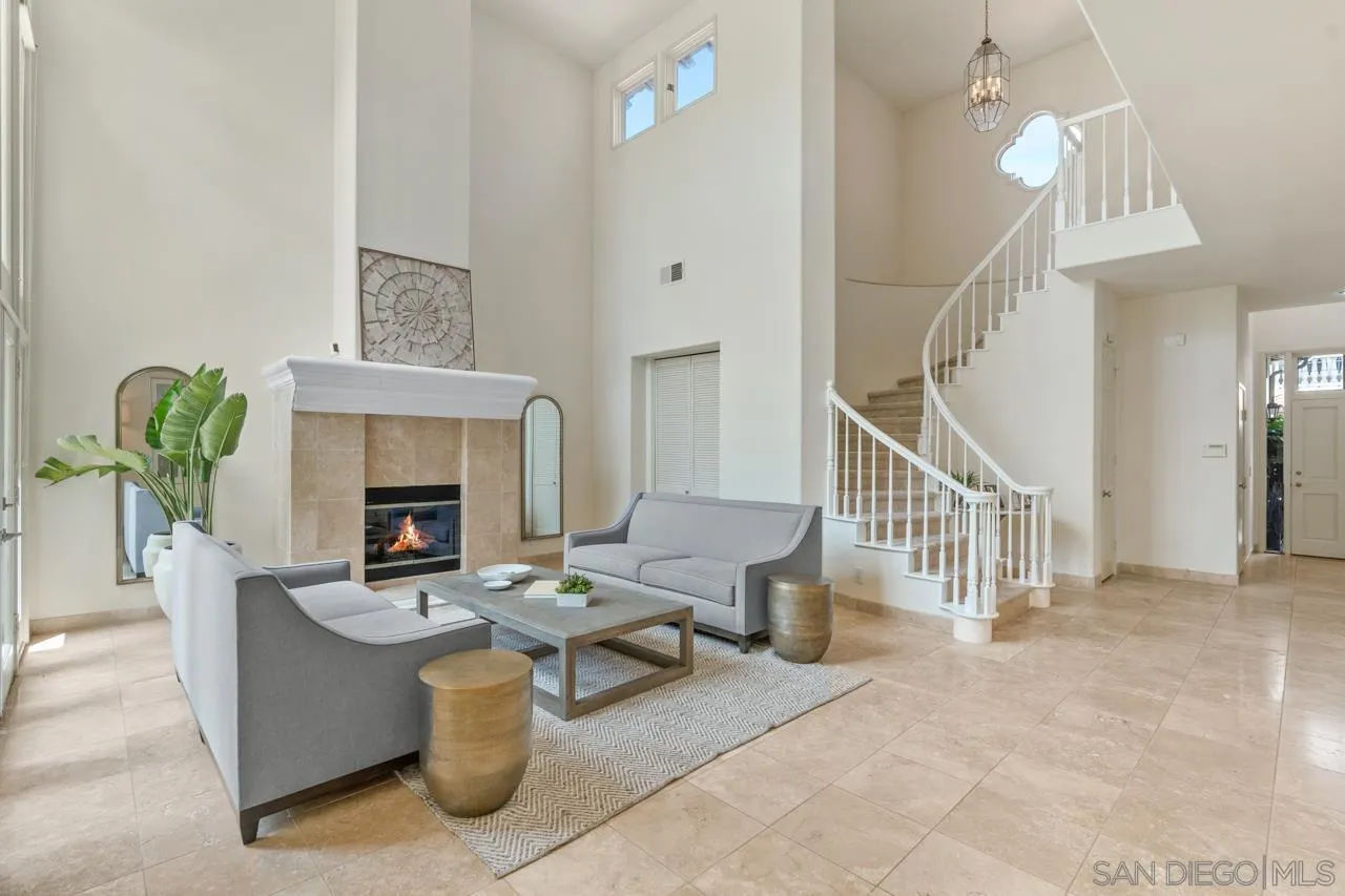 9678 Claiborne Square La Jolla, CA 92037 - Photo 7 of 38 a living room with furniture a fireplace and a chandelier