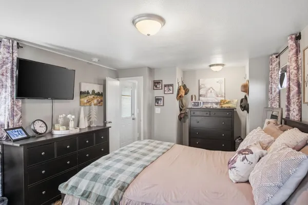 a bedroom with a bed and a flat screen tv