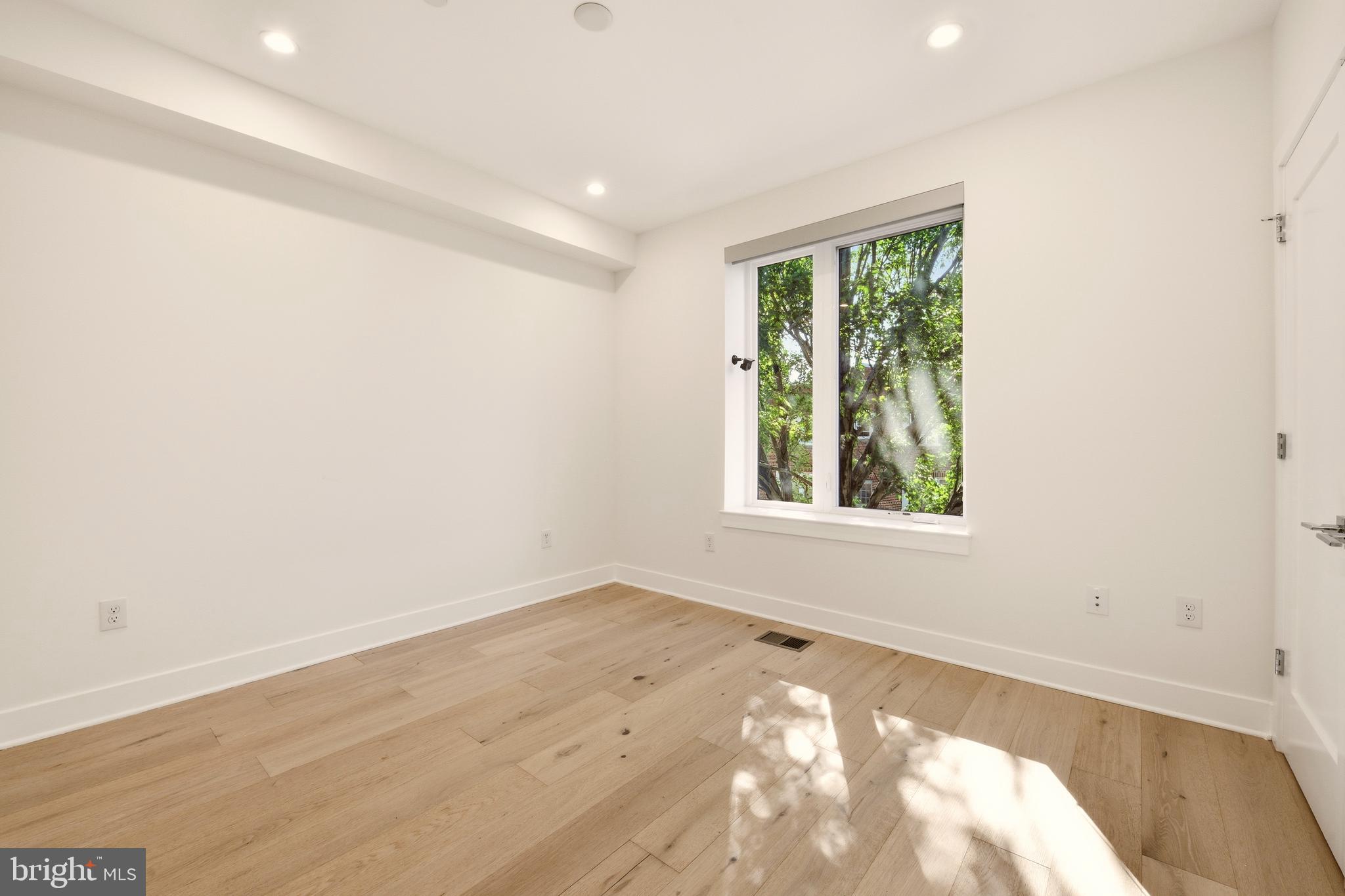 1023 16th Street Northeast, Unit B Washington, DC 20002 - Photo 16 of 25 an empty room with wooden floor and windows