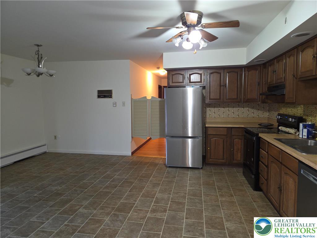 2280 Linden Street, Unit 2N Bethlehem, PA 18017 - Photo 5 of 14 a kitchen with stainless steel appliances granite countertop a refrigerator a stove a sink dishwasher and a refrigerator with wooden floor