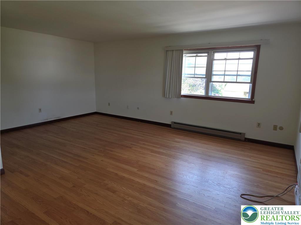 2280 Linden Street, Unit 2N Bethlehem, PA 18017 - Photo 8 of 14 an empty room with wooden floor and windows