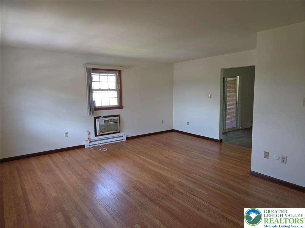 2280 Linden Street, Unit 2N Bethlehem, PA 18017 - Photo 9 of 14 an empty room with wooden floor cabinet and windows