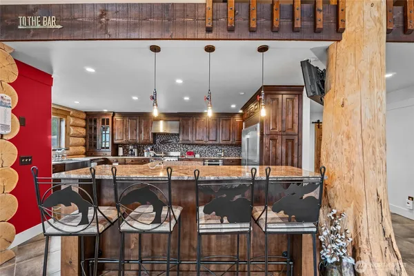 a kitchen with a table and chairs
