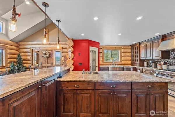 a kitchen with stainless steel appliances granite countertop a sink and dishwasher cabinets with wooden floor